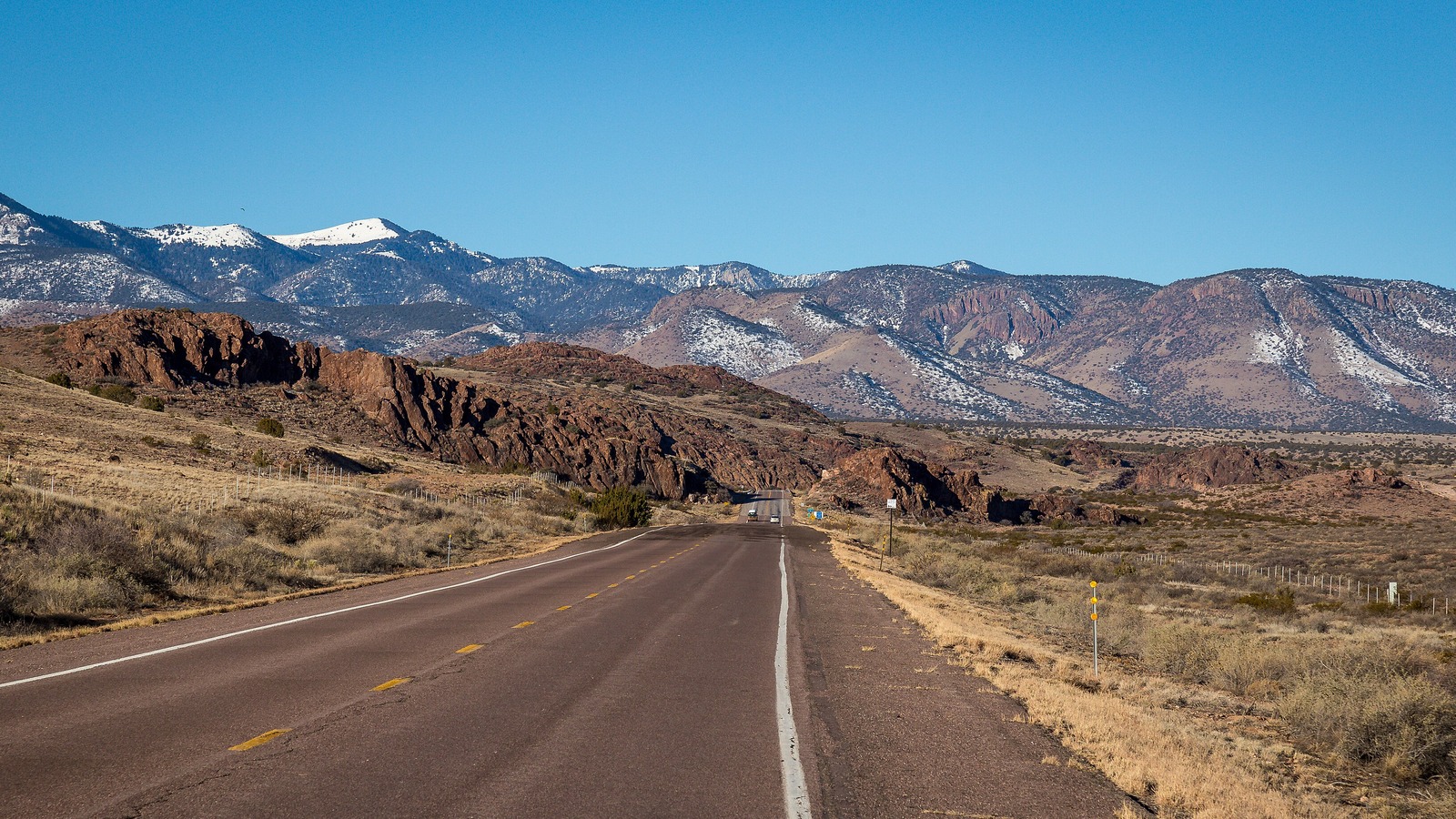 U.S. Route 60 near Socorro, New Mexico, running toward snow dusted mountains