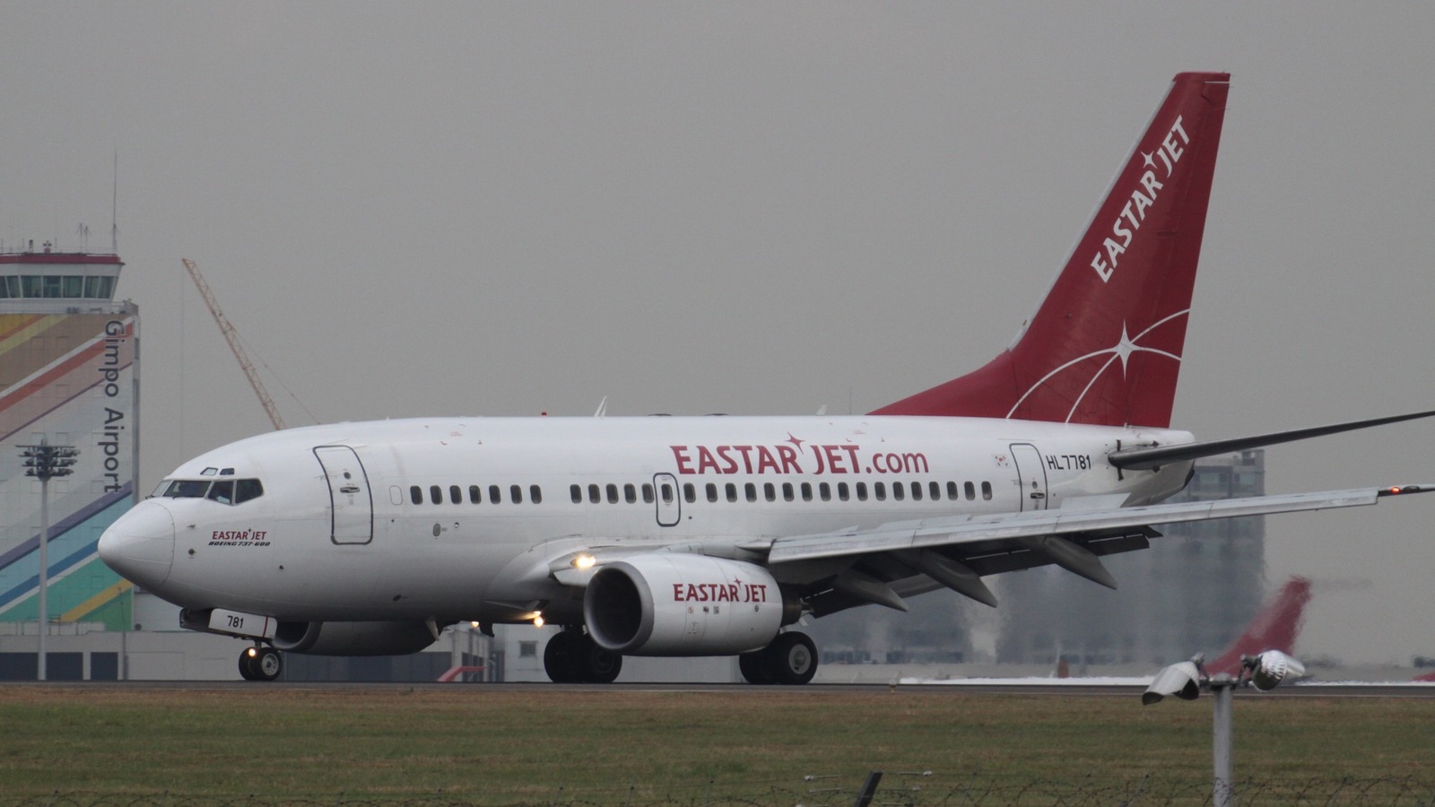 Eastar Jet Boeing 737-800 HL7781 on the taxiway at Seoul Gimpo International Airport, with the airline titles on the fuselage and red tail.