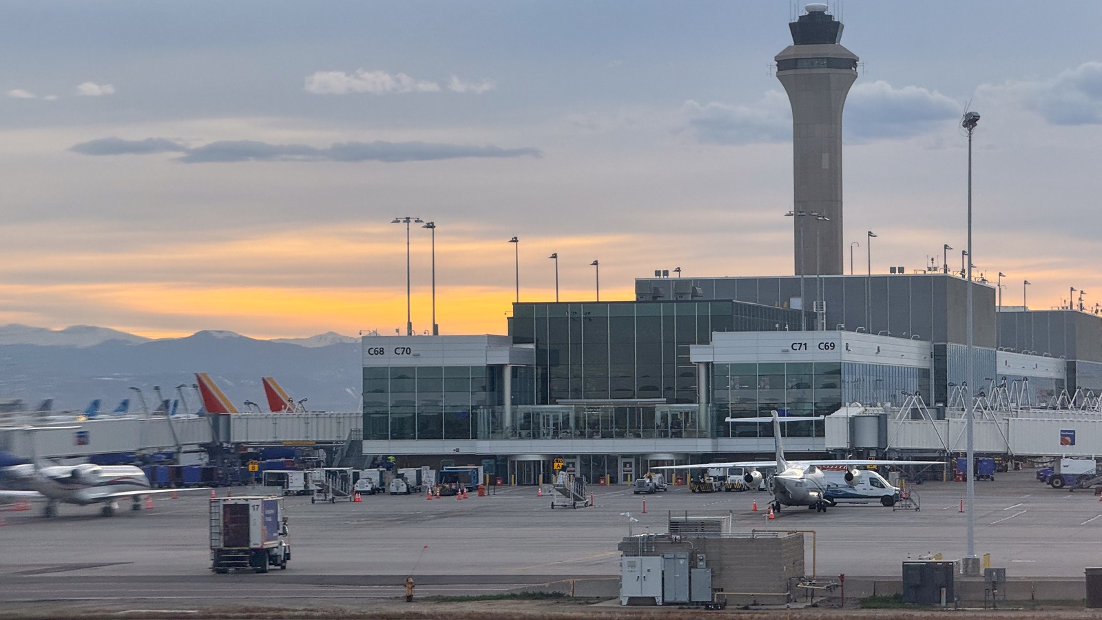 Denver airport Concourse C gates and control tower at sunset in April 2024