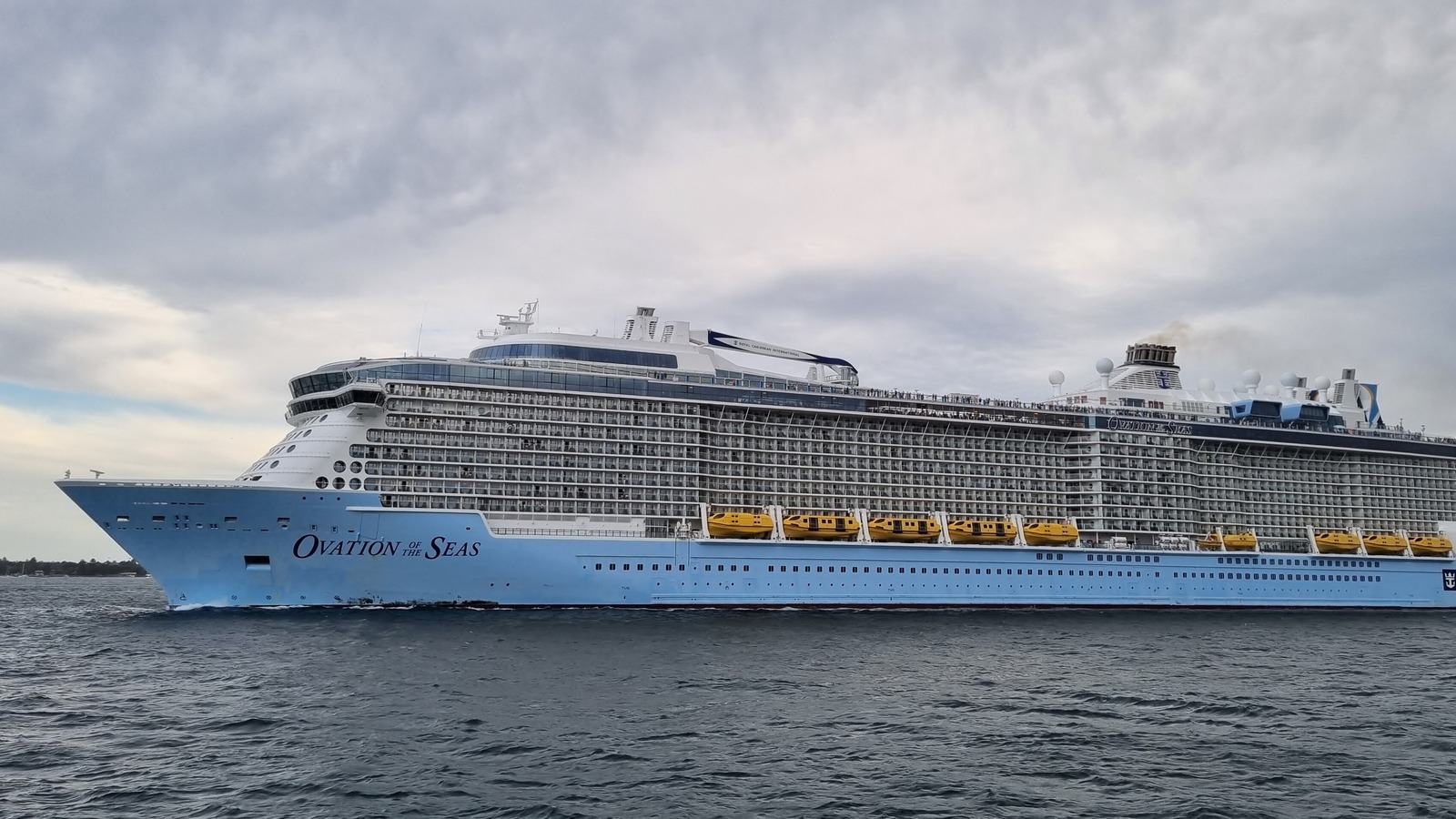 Ovation of the Seas cruise ship under way in Sydney Harbour with its name on the bow