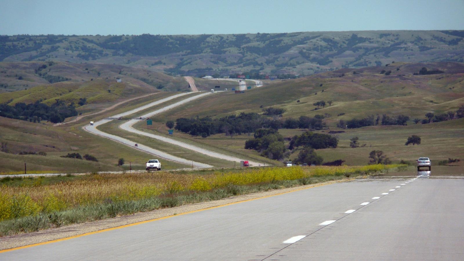 Twisted interstate highway stretching through South Dakota under a wide sky