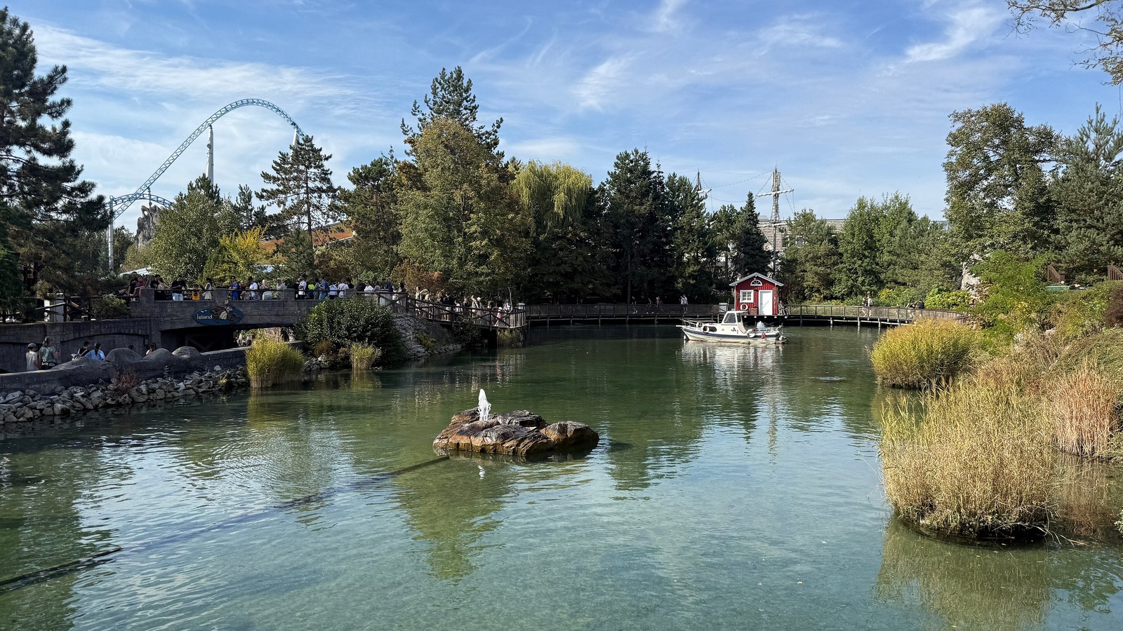 Lake and harbor scene in the Iceland themed area of Europa-Park with the blue fire coaster track behind the trees, photographed September 30, 2026