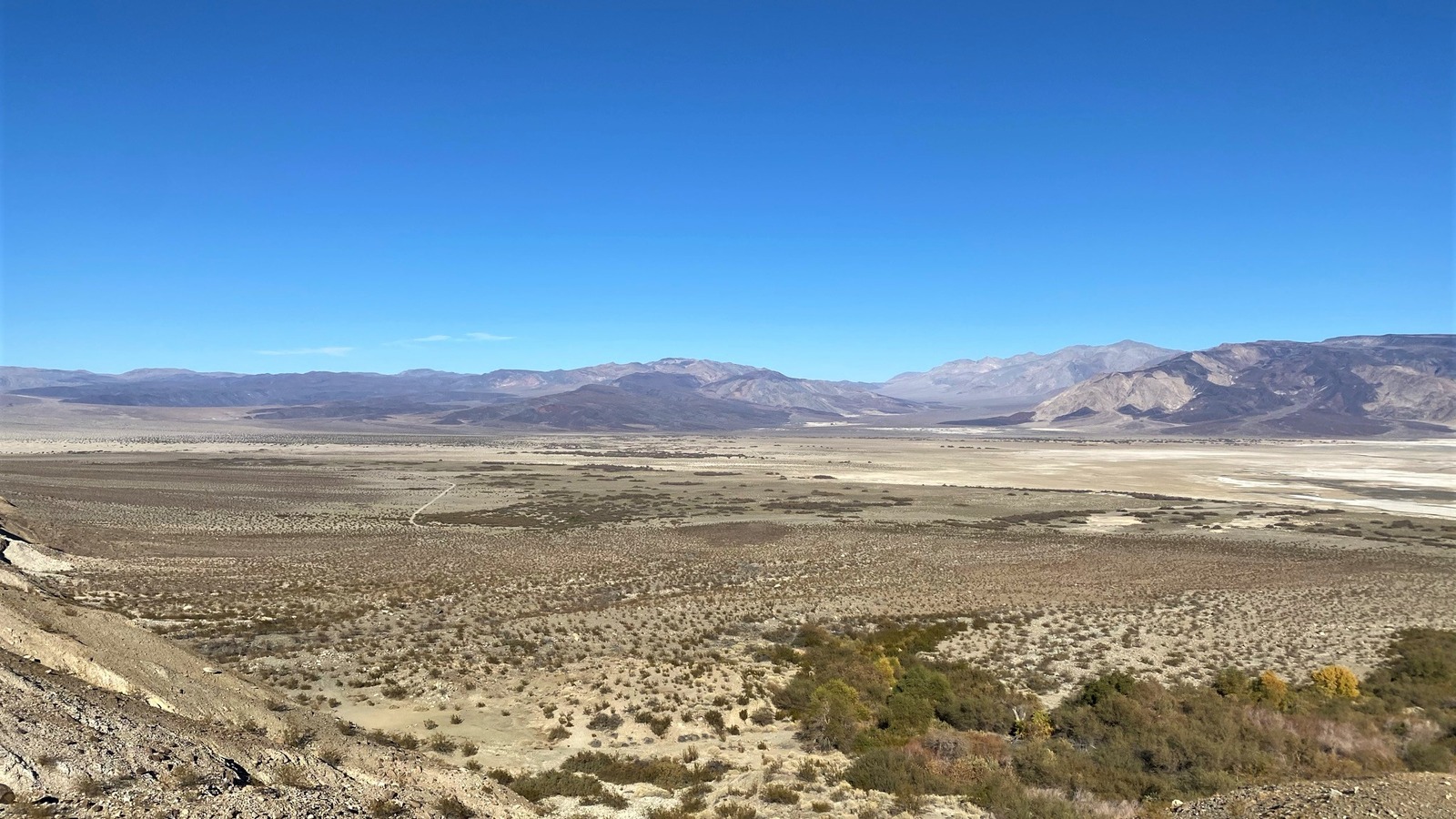 Overlook of Saline Valley in Death Valley National Park, a wide desert basin with scrub and mountains under a clear blue sky