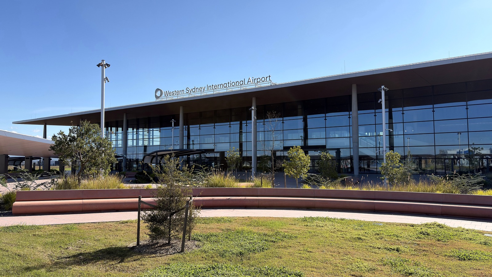 Terminal building of Western Sydney International Airport with the airport name on the roofline