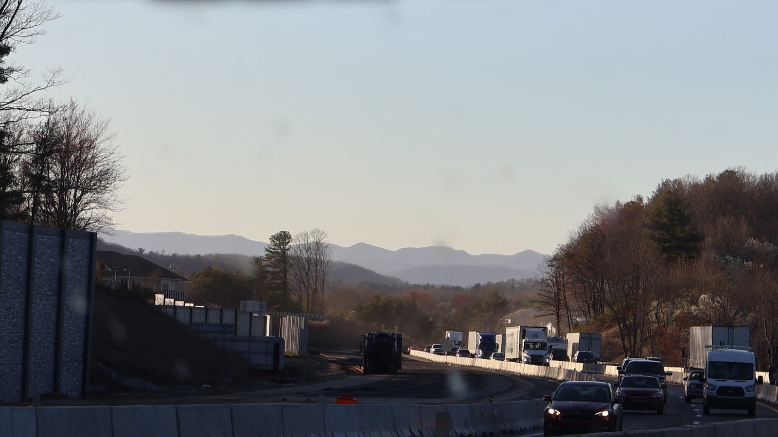 Eastbound Interstate 26 traffic and construction barriers in Henderson County, North Carolina, with mountains ahead