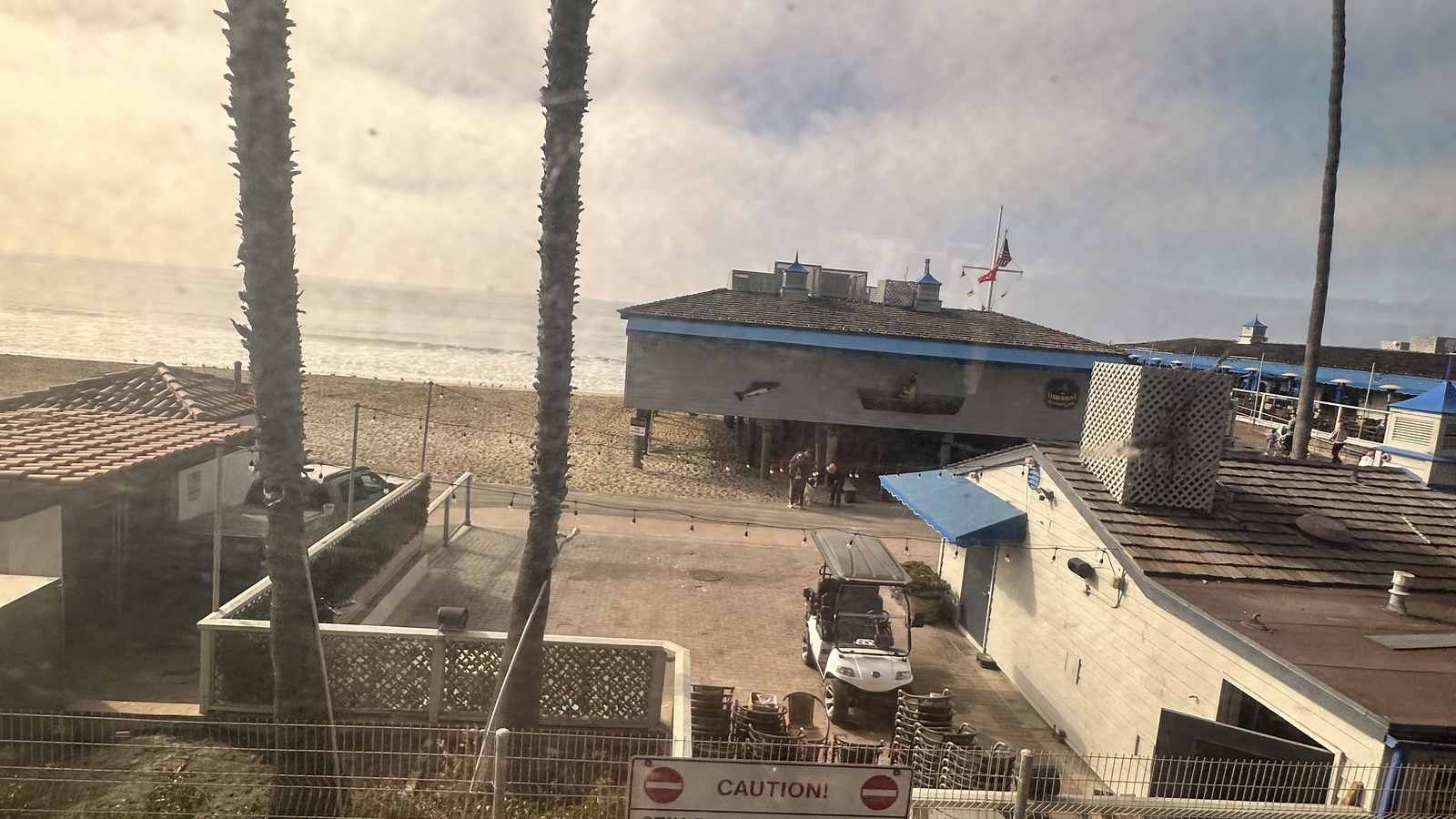 San Clemente beach buildings, palms, and ocean viewed from the Pacific Surfliner coastal rail line