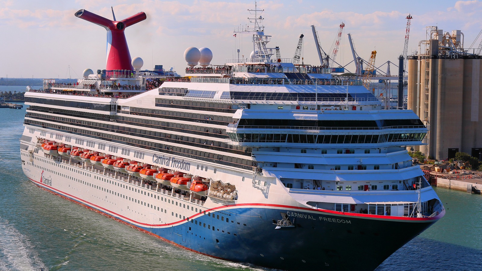 Carnival Freedom cruise ship with its red and blue whale tail funnel sailing out of Port Canaveral, Florida