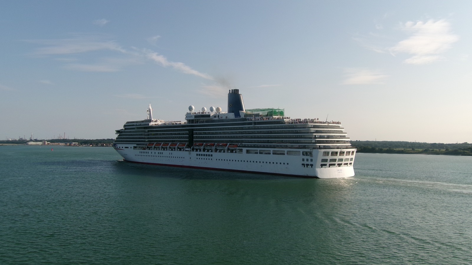 P&O Cruises ship Arcadia underway in daylight on Southampton Water, white hull and dark funnel, photographed in 2024