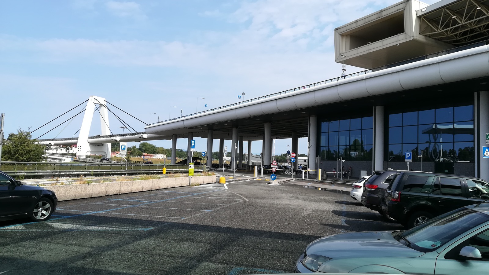 Milan Malpensa Airport Terminal 1 exterior and the cable-stayed access bridge in daylight