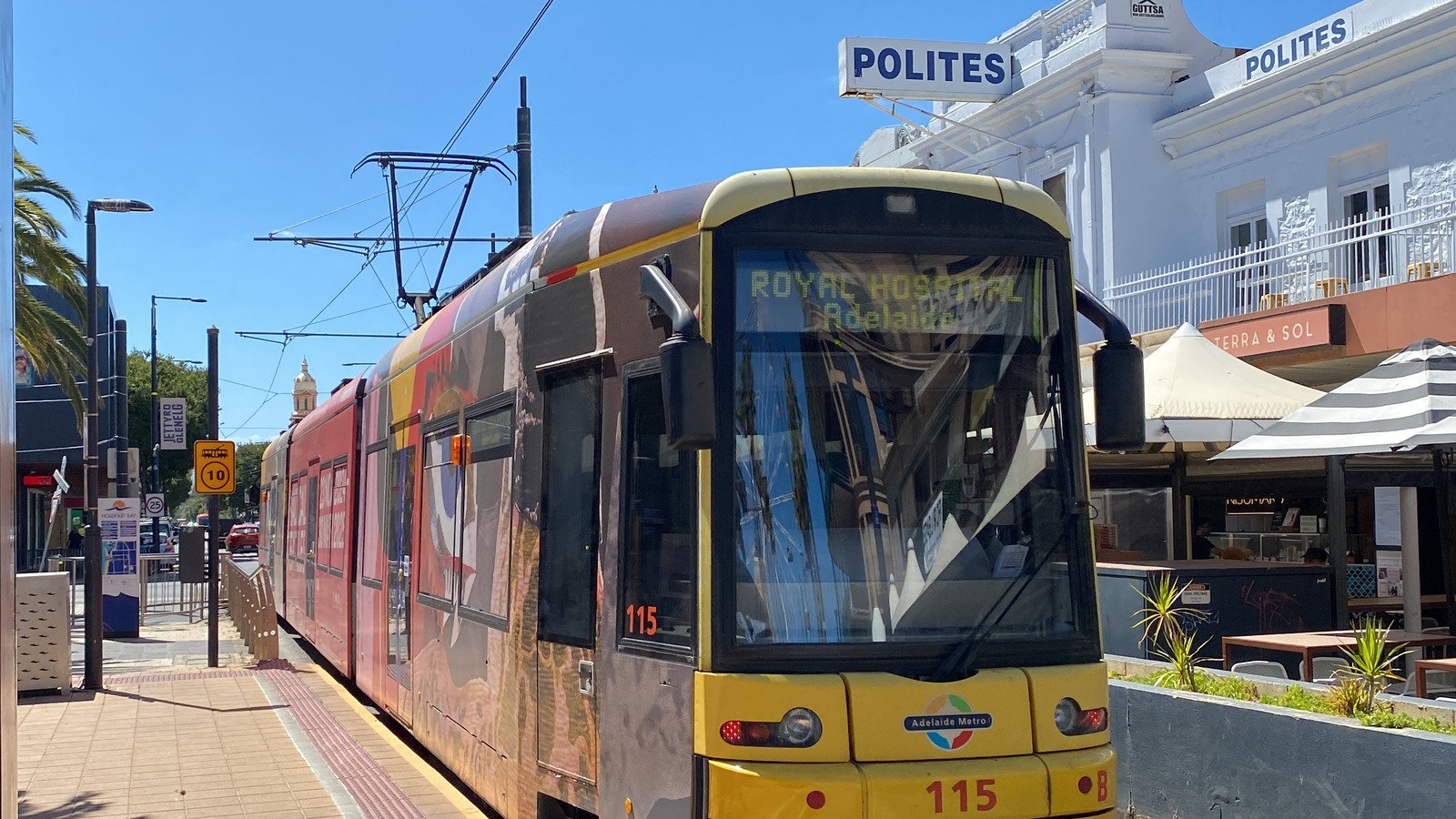 Glenelg tram departing Moseley Square along Jetty Road on a sunny day