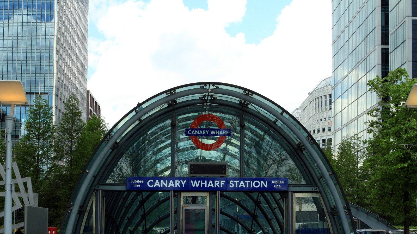 Glass arched street entrance to Canary Wharf Underground station on the Jubilee line in London