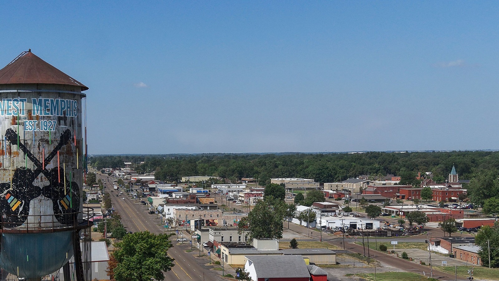 Aerial view of a main street in downtown West Memphis, Arkansas, with the West Memphis water tower at left