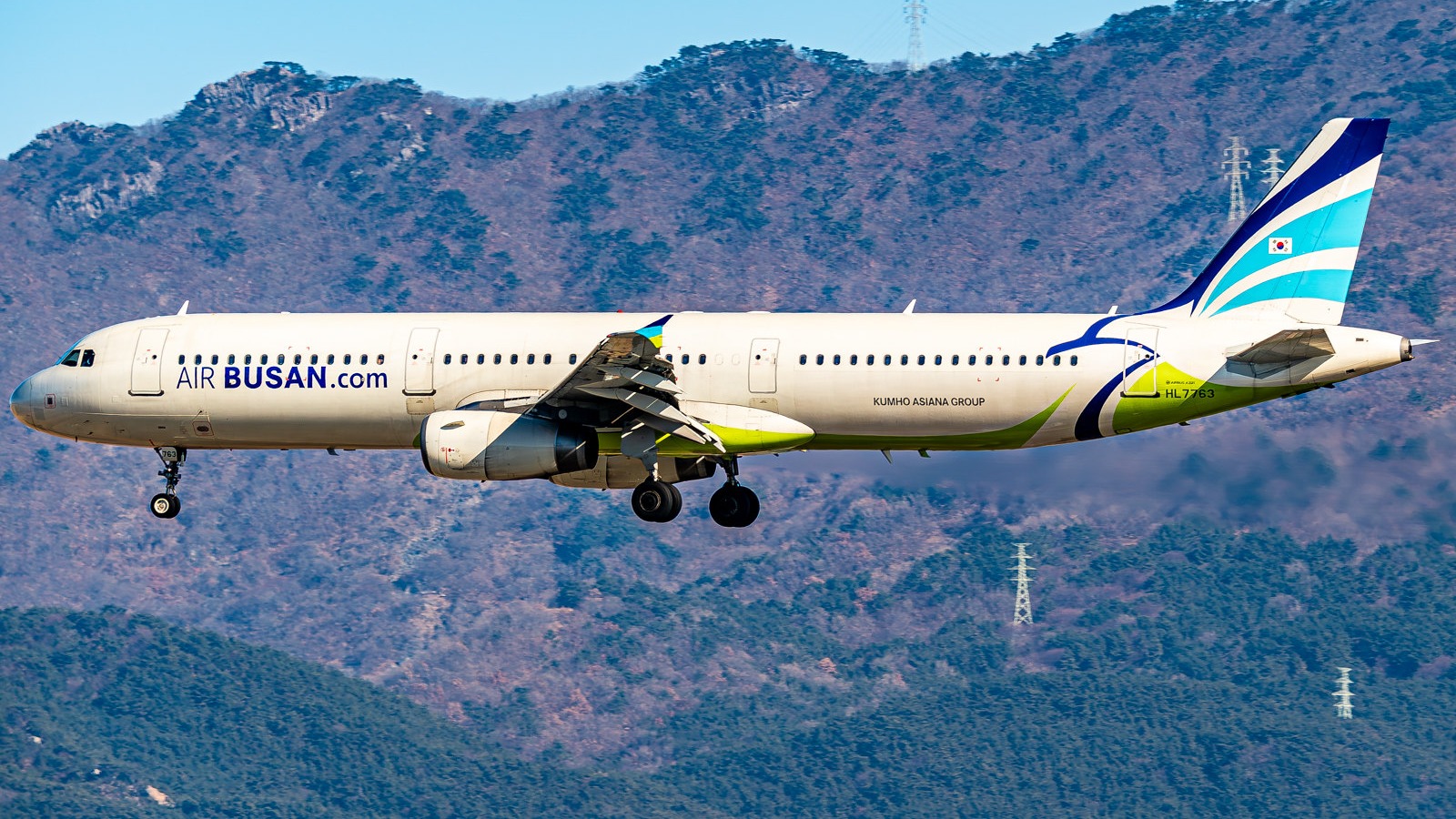 Air Busan Airbus A321 approaching Gimhae International Airport in daylight
