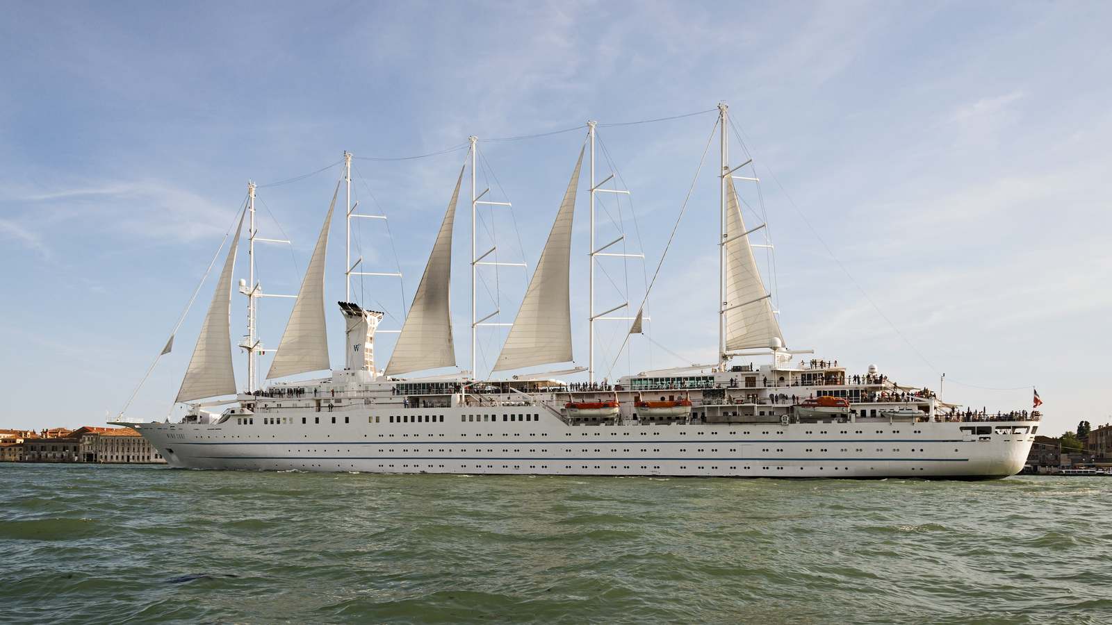 Windstar sailing cruise ship Wind Surf under sail in the Giudecca Canal in Venice