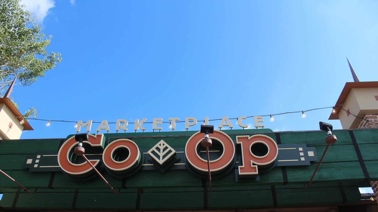 Marketplace Co-Op sign at Disney Springs Marketplace under a blue sky