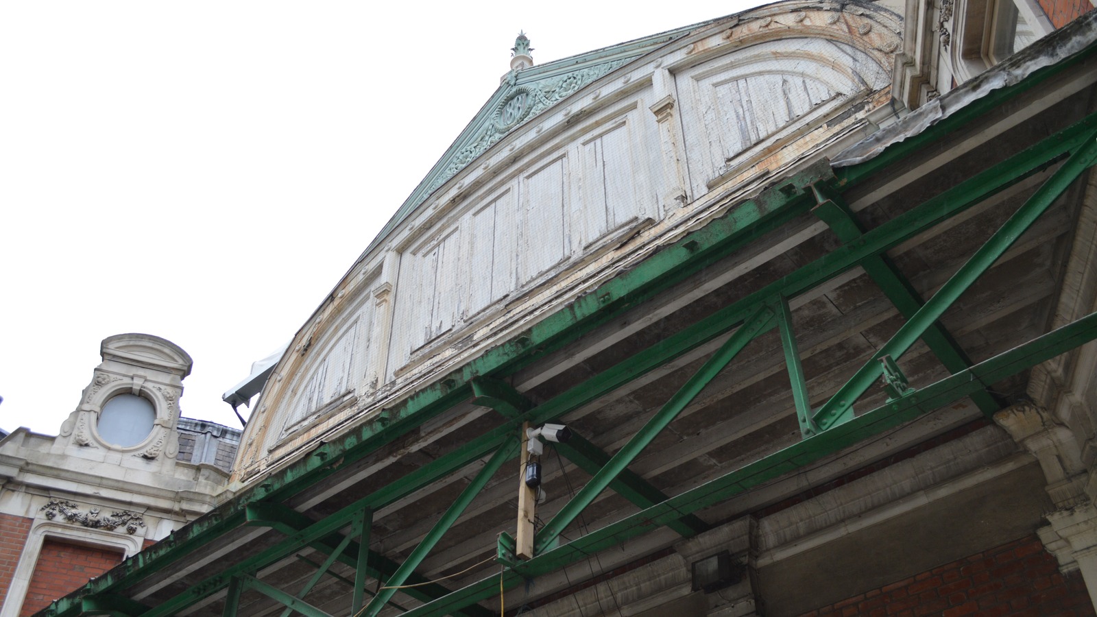 Daytime exterior entrance of Smithfield Market, the future London Museum home, with market signage above the archway