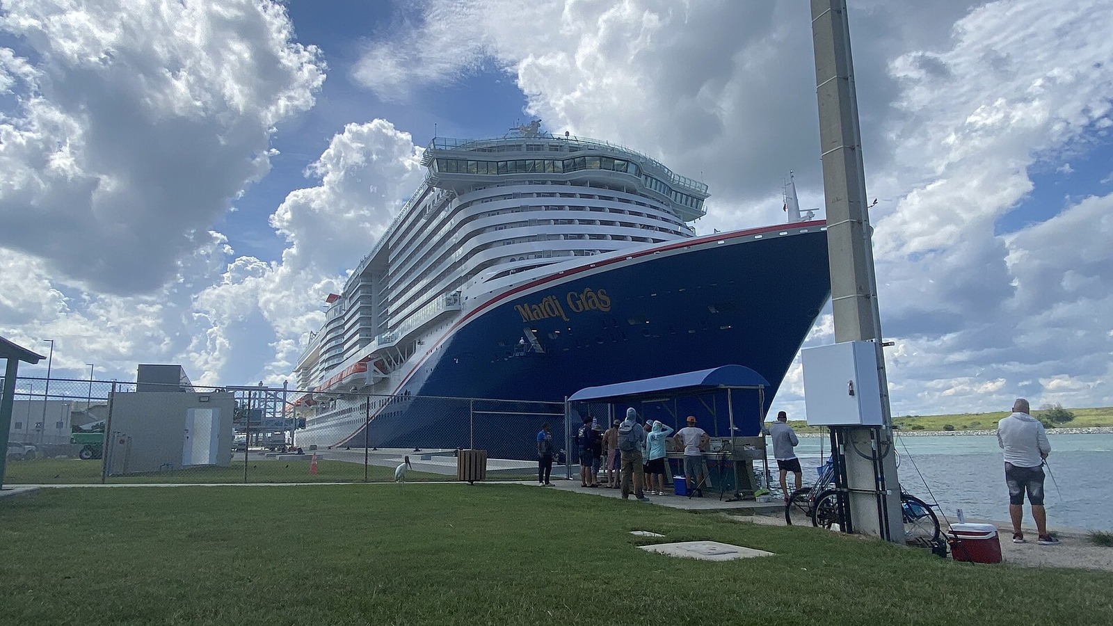 Carnival Mardi Gras docked at Port Canaveral under a partly cloudy sky