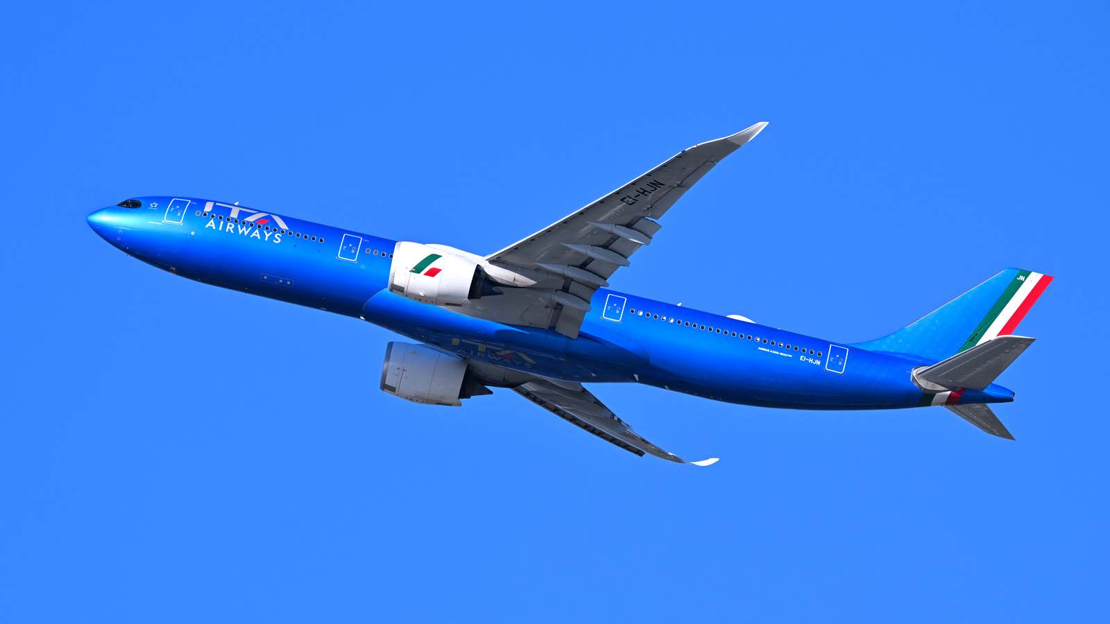 ITA Airways Airbus A330-900 registration EI-HJN climbing against a clear blue sky