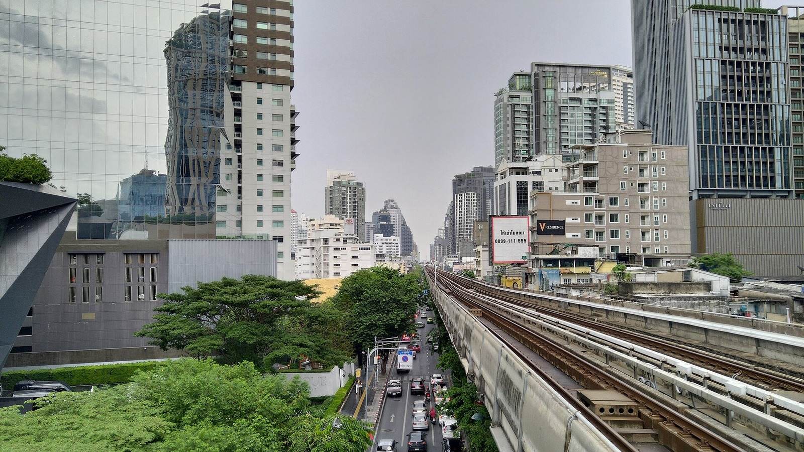 Sukhumvit Road and the BTS Skytrain tracks near Phrom Phong station in Bangkok on a cloudy day