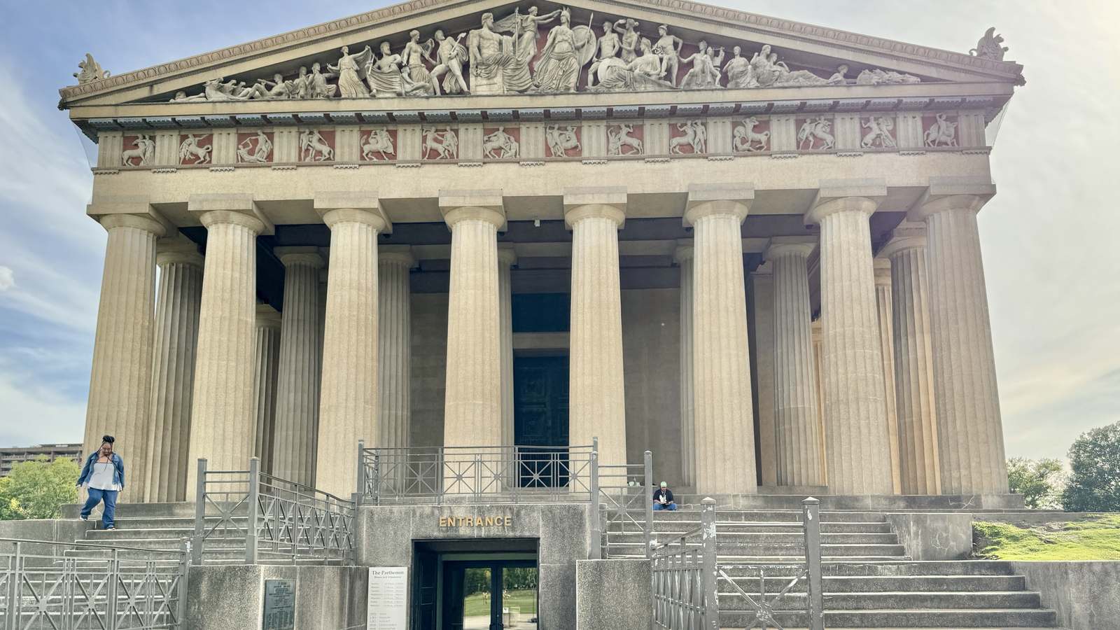 The Parthenon replica in Centennial Park, Nashville, with its columns and sculpted pediment under a bright sky.