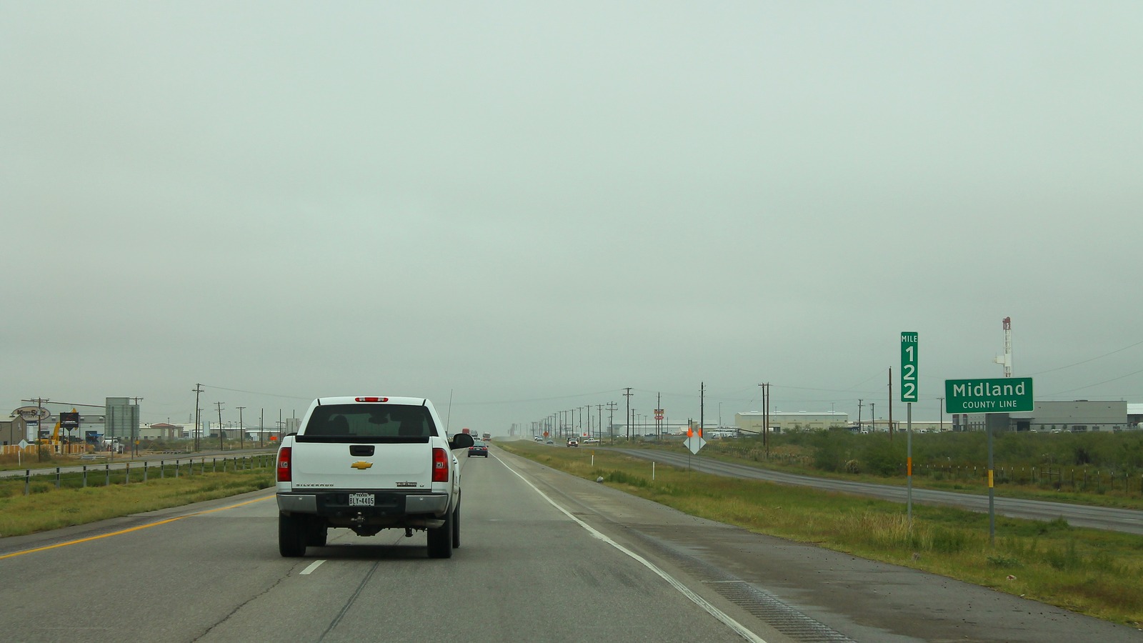 Eastbound Interstate 20 entering Midland County Texas under a clear sky
