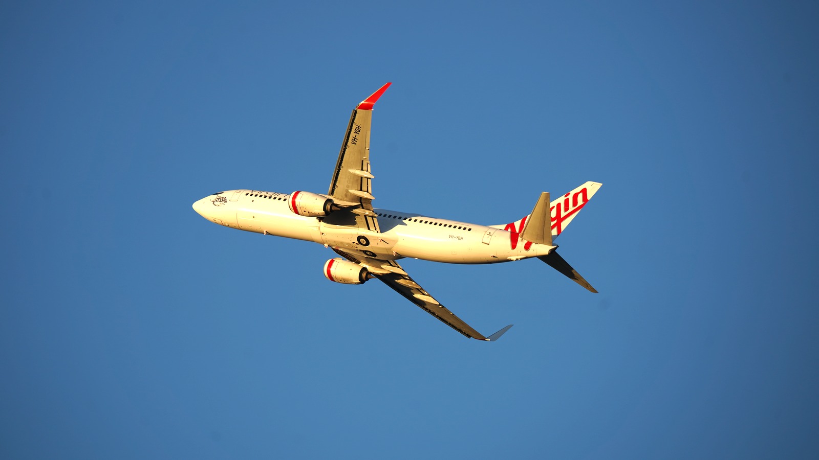 Virgin Australia aircraft VH-YQH taking off from Sydney Airport in May 2025
