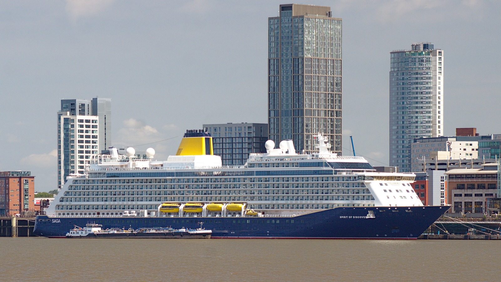 Saga Cruises ship Spirit of Discovery berthed at Liverpool Cruise Terminal, starboard profile with yellow funnel