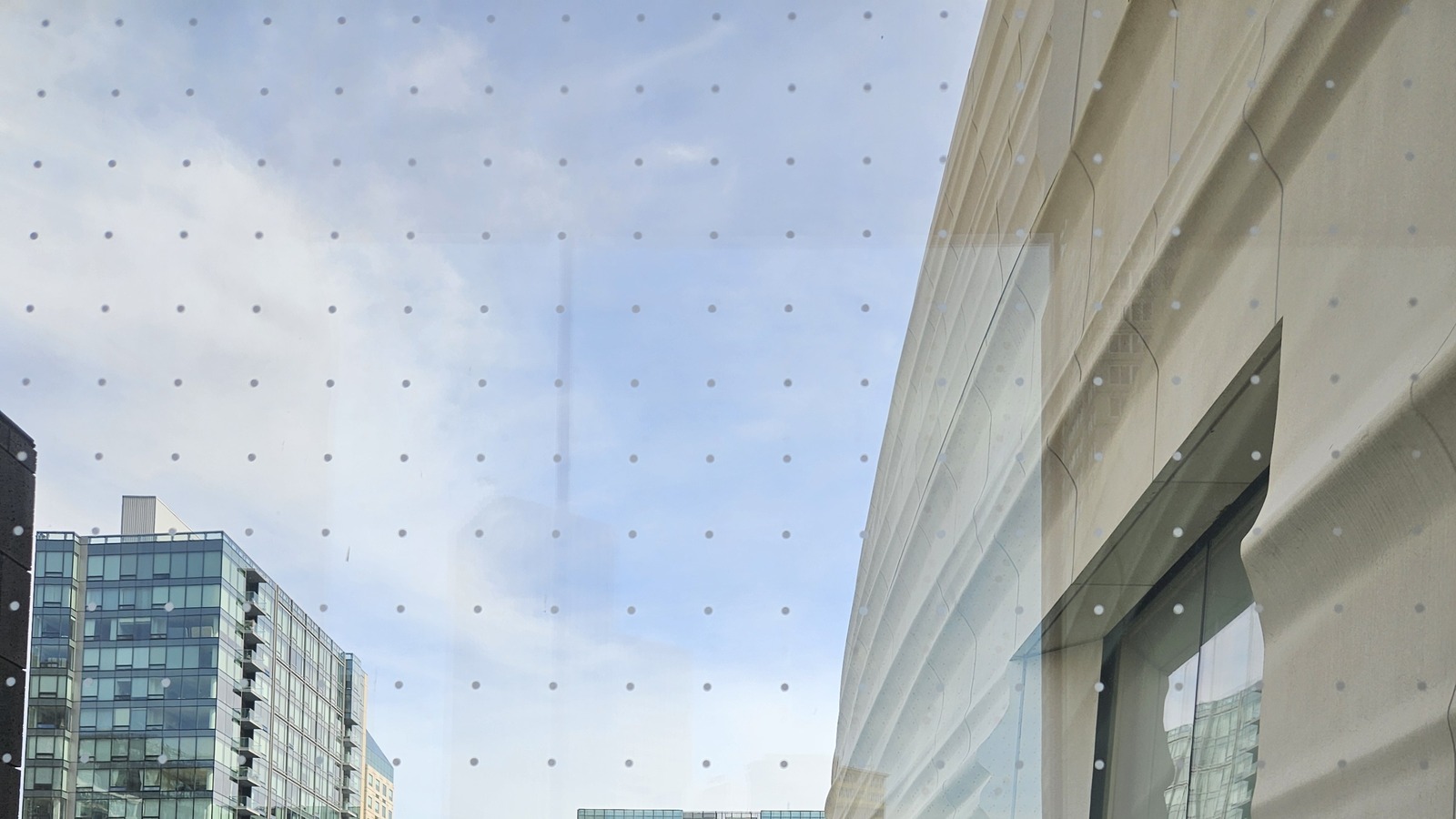 SFMOMA's white facade viewed through glass in San Francisco, photographed April 15, 2025