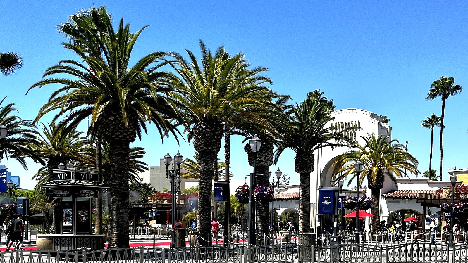 Palm trees and the entrance arch of Universal Studios Hollywood on a sunny day in July 2022