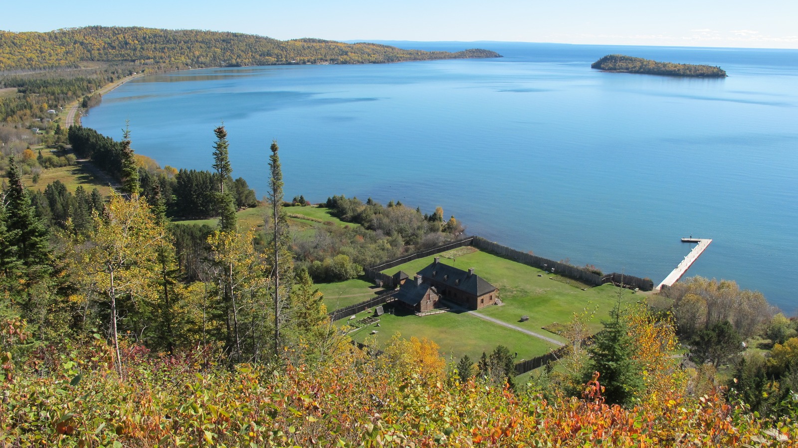 Wooden palisade and reconstructed Historic Depot buildings on Grand Portage Bay, Lake Superior, seen from the Mount Rose Trail overlook