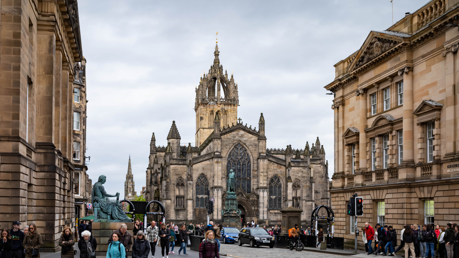 The Royal Mile in Edinburgh with historic stone buildings and a broad daylight street view.