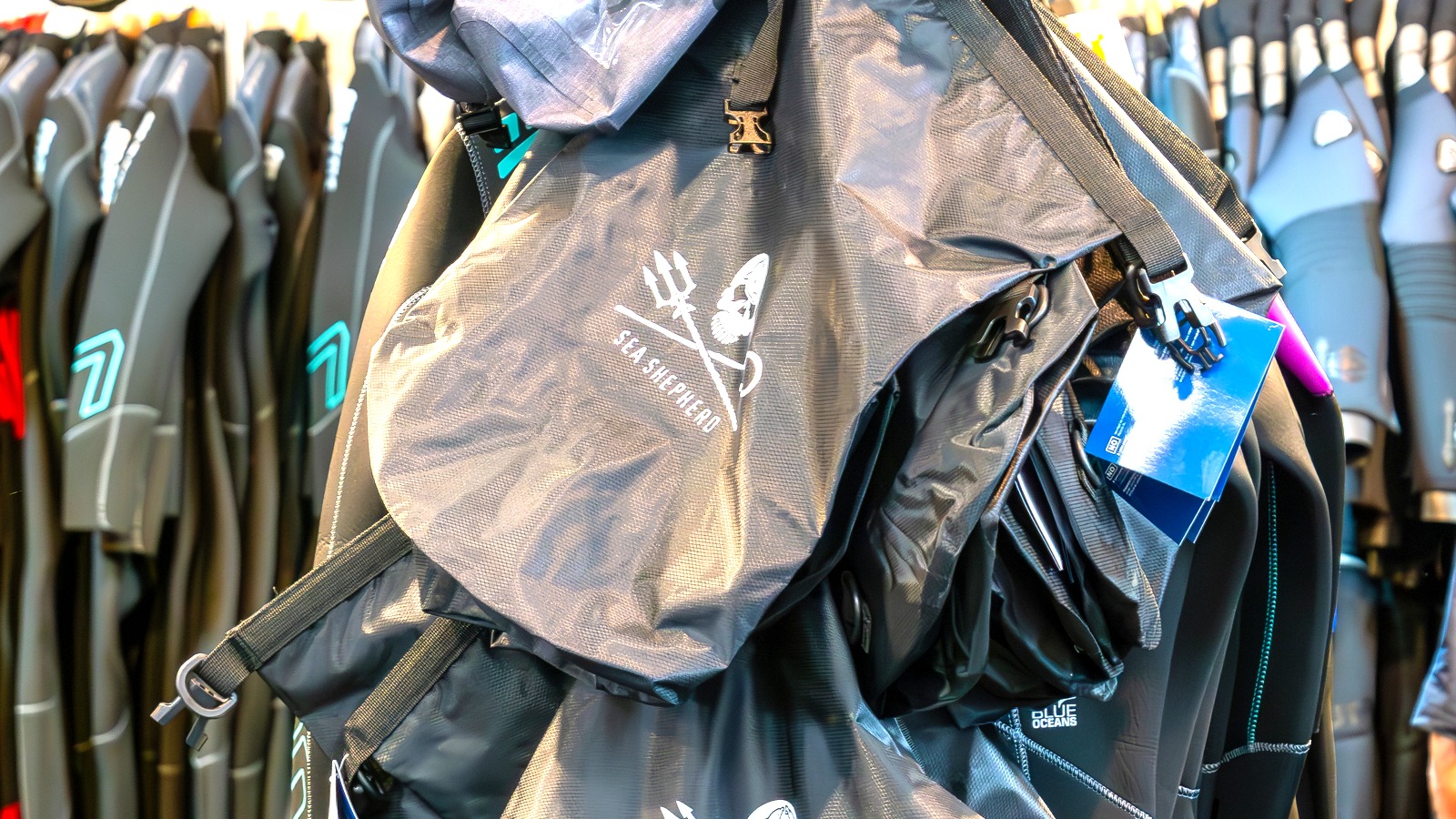 Sea Shepherd branded dry bags with straps and clips on display at InterDive 2023.