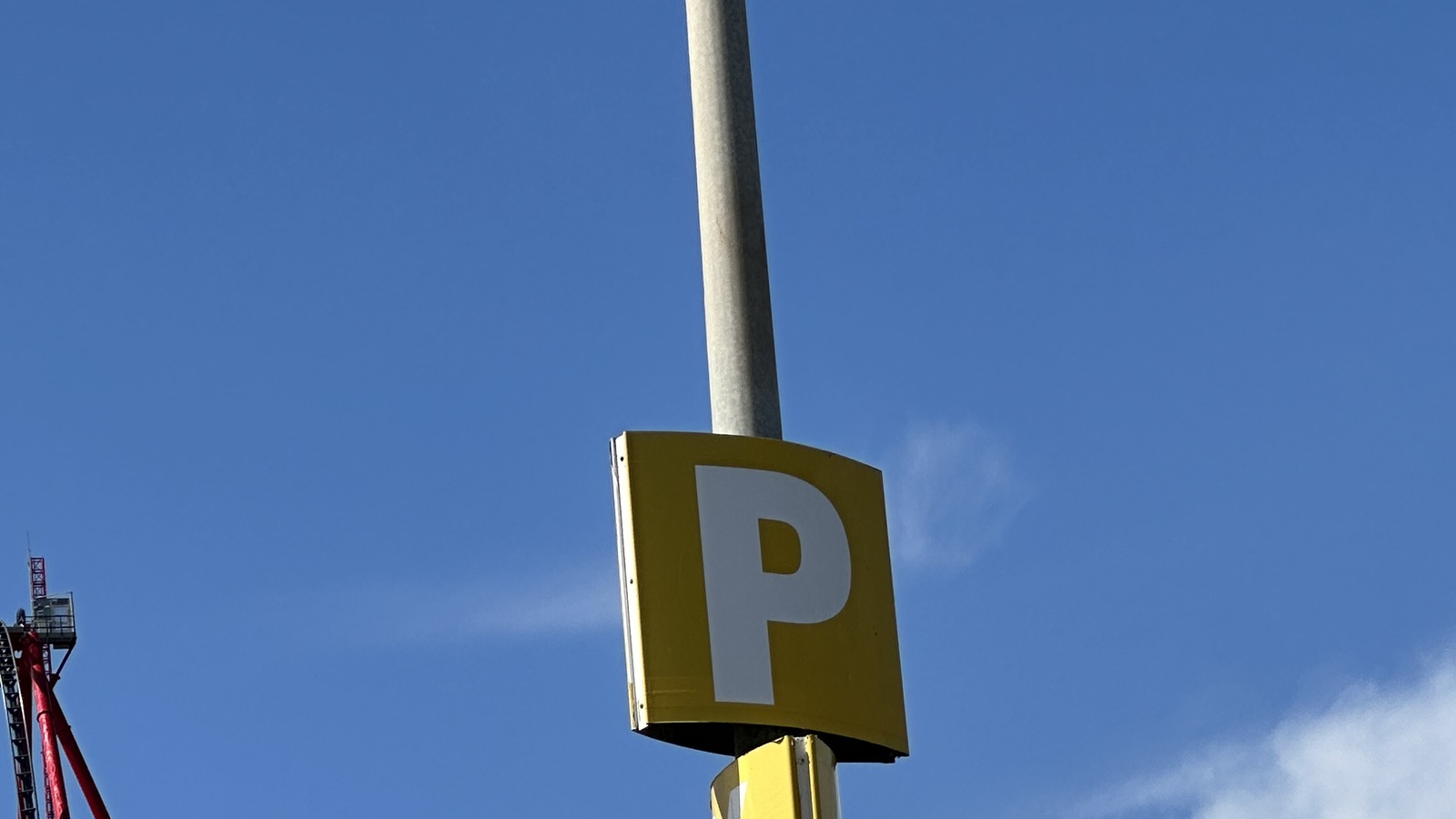 A yellow P parking sign and the red Ferrari Land tower are visible at PortAventura World.